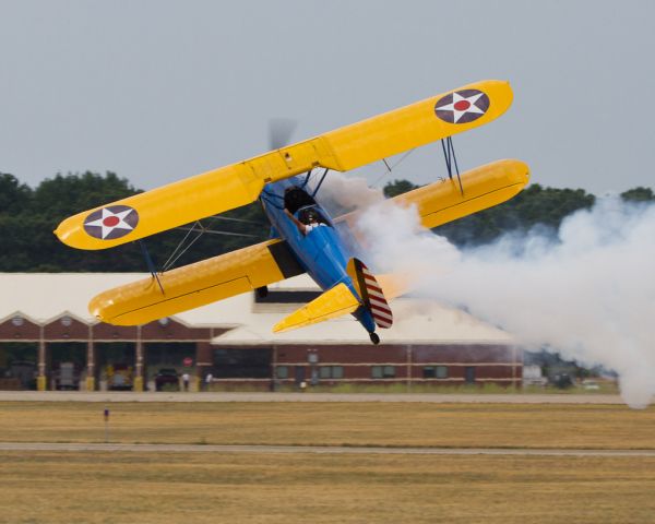 N49739 — - John Mohr waves to the crowd from just a few feet off the ground, showing off the yellow wings of his 1943 Boeing Stearman PT-17 “Kaydet” Stock 220, a US Army training aircraft.