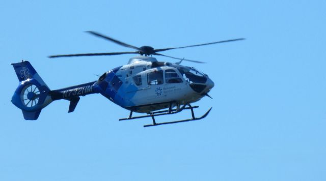 Eurocopter EC-635 (N732HM) - Making a low pass is this 2006 Eurocopter EC-135 in the Autumn of 2022.