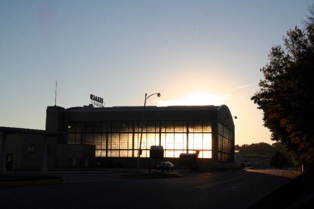 — — - This is home base at Capital City Airport in Harrisburg, PA.  Photo is of main hangar #1 with the sun behind the hangar.  You can make out the silouette of a larger plane inside the hangar.