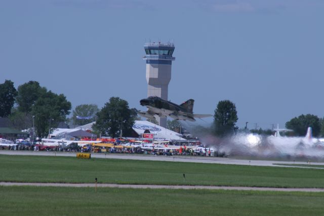 — — - EAA 2010 Crowd in the Background as F-4 Departs Runway 18