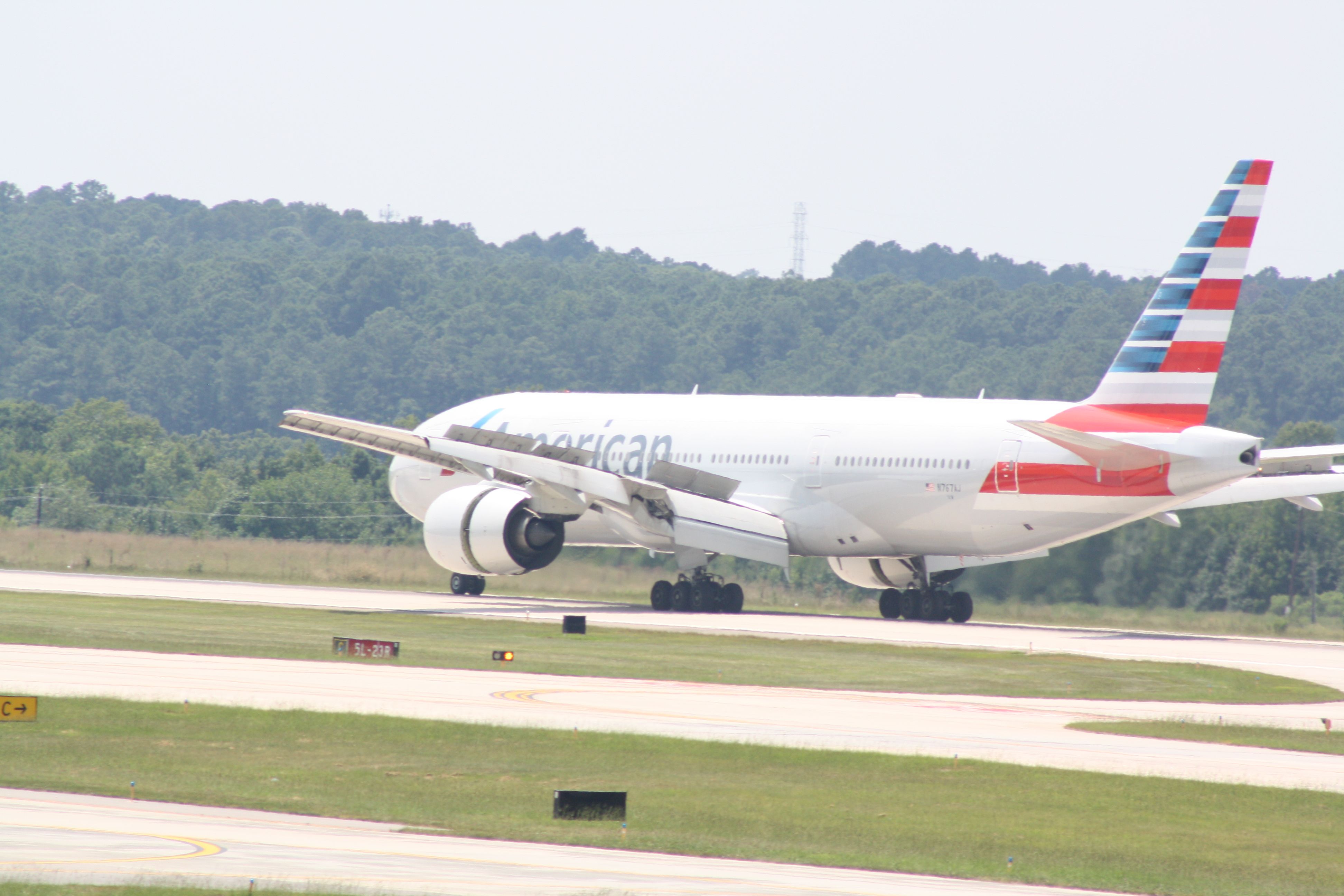 Boeing 777-200 (N767AJ) - N767AJ landing roll out runway 23R