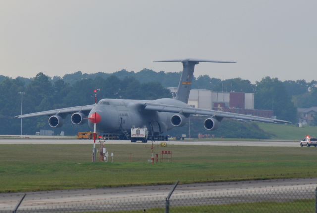 Lockheed C-5 Galaxy (86-0013) - 86-0013 (cn 500-0099) Freighter flashback Friday.. This was my first sighting of the very first Lockheed C-5M Super Galaxy at the beginning of the C-5 Reliability Enhancement and Re-Engining Program (RERP). On the afternoon of 22 Sep 2006, I watched it takeoff, circle around, and immediately return but didn’t have my camera. It experienced hot-brakes after it landed on RWY 11 and several blasts could be heard as multiple tires exploded from the increased heat/pressure. Luckily, I was able to grab my camera and while not the sharpest, I snapped these long-distance shots. Lockheed Firefighters and aircraft maintenance crews quickly took control of the situation. If you look closely, you can see the left-front main bogie is raised. 86-0013 was originally delivered in 1987 as a C-5B, converted to C-5M and later delivered to Dover AFB. It is still assigned to Dover AFB DE where the 436th AW & 512th AW are collocated.