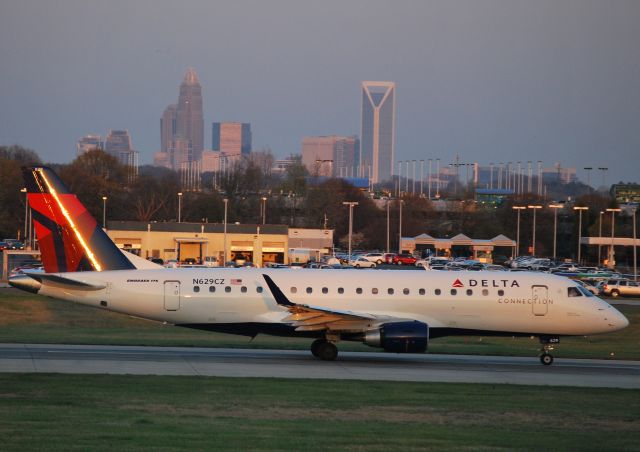 Embraer 170/175 (N629CZ) - Rolling 18C as the setting sun reflects off the tail - 3/18/11