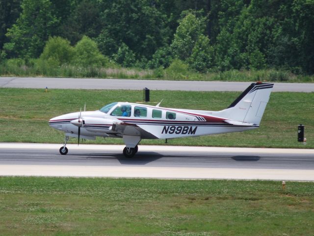 Beechcraft Baron (58) (N99BM) - Rolling down runway 20 at KJQF - 6/9/09