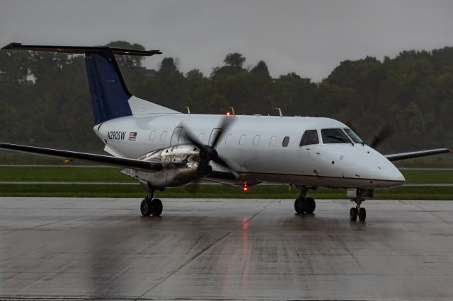 Embraer EMB-120 Brasilia (N290SW) - Berry Aviation 664 taxiing to park at Butler County Regional in the pouring rain.