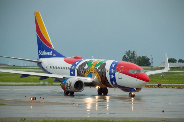 Boeing 737-700 (N280WN) - Missouri One is taxing out to Runway 13 for departure out to St. Louis as SWA 633. This flight was delayed by 20 minutes due to a fierce early morning storm including dime size hail. Photo taken June 28, 2020 at 7:10 AM with Nikon D3200 at 185mm. 