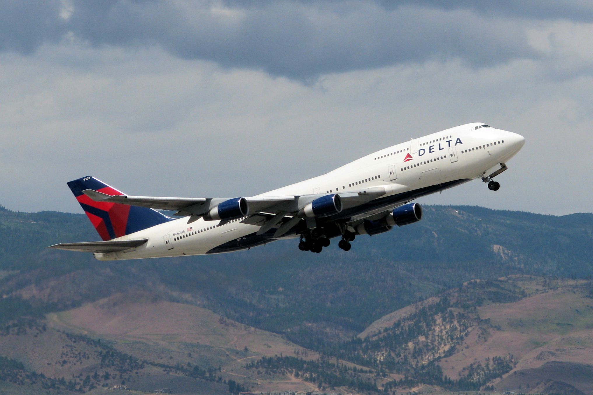 Boeing 747-400 (N662US) - Seen for the first time in the Flight Aware photo section wearing its new livery, this picture of N662US was taken less than 2.5 hours ago and is being posted here while the aircraft still has 90 minutes to go to reach its destination at KCEF (Westover ARB, Chicopee, Mass).  This photo shows her climbing out from Reno Tahoe Internationals runway 34L on a military charter flight transporting U.S. Marines home after a grueling two week training exercise in the Nevada desert.