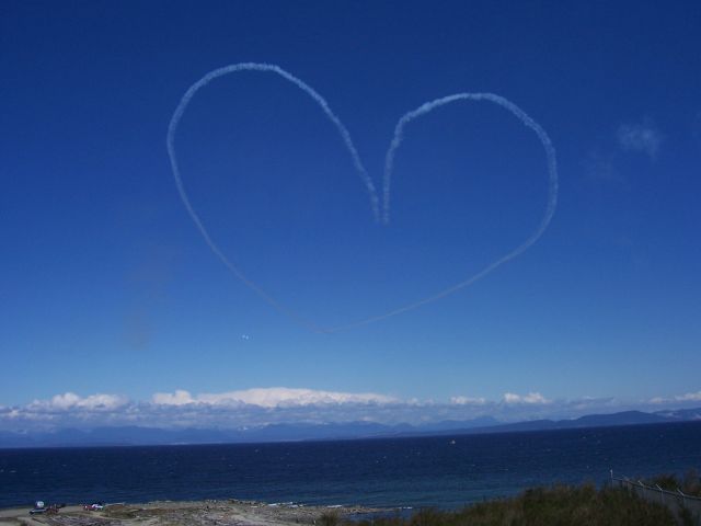 — — - WE LOVE Our CANADIAN SNOWBIRDS    A pair of CT-114 Canadair Tutors  complete a classic 1,000 foot Heart over the shores of CFB Comox, BC