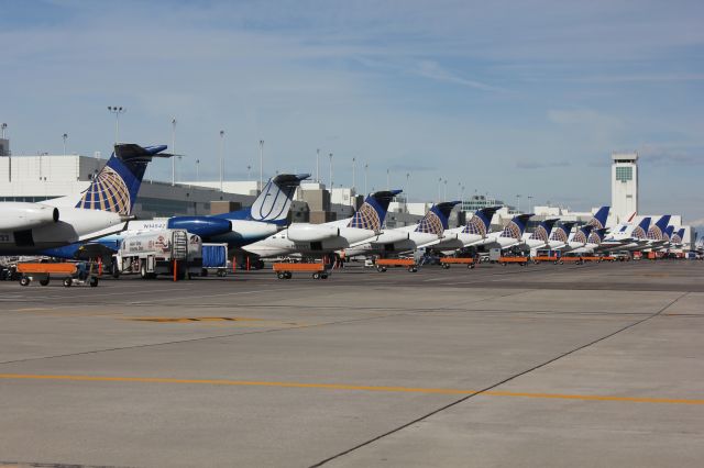 Embraer ERJ-145 (N14542) - A row of United regional jets parked along the north side of concourse B at DIA.