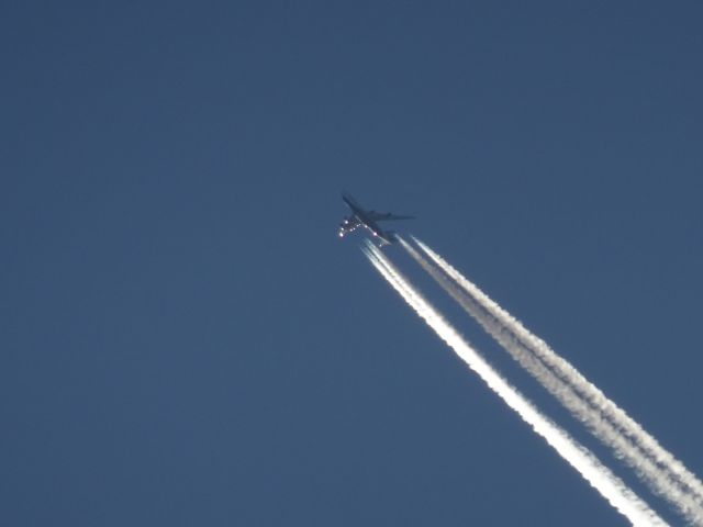 — — - Nippon Air Cargo flying over Fargo in the evening.