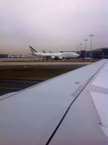 Boeing 747-200 — - Taxi past an Air France 747-400 at DeGaulle in Paris.  Nasty airport.