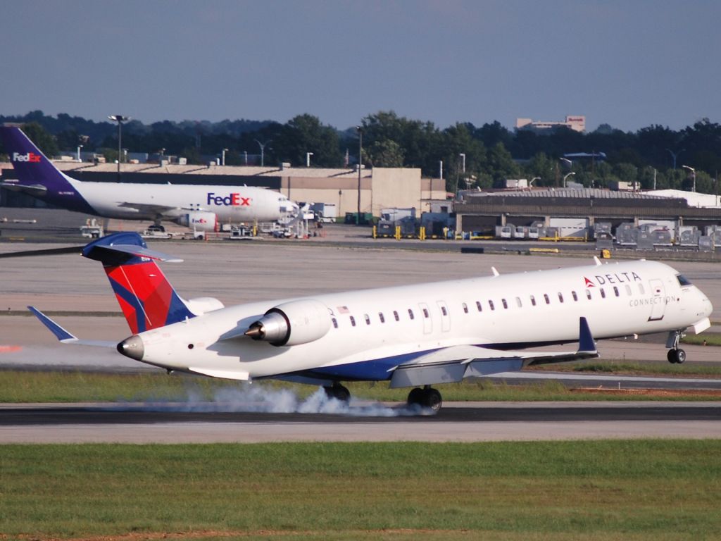 Canadair Regional Jet CRJ-900 (N176PQ) - Touching down on runway 18C - 9/27/009