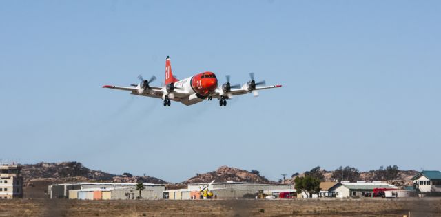 — — - Aero Union P3 Orion firefighting aircraft on low take of pass out of Ramona, California.