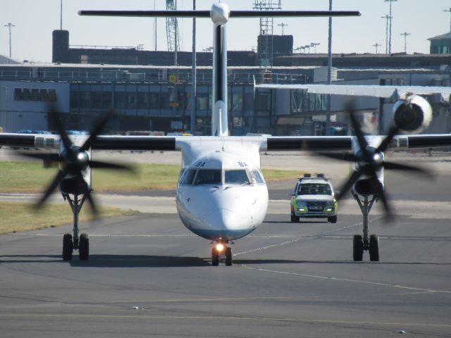 de Havilland Dash 8-400 (G-FLBA) - Taken from Manchester Runway Visitor Park. Taxing to 05L for takeoff (30 June 2018). Airfield Ops vehicle following