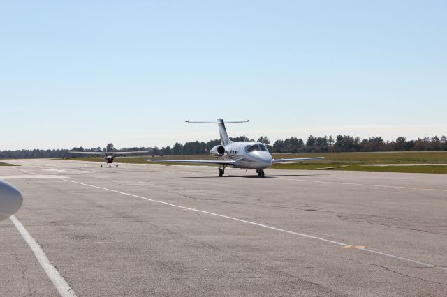 — — - All sorts of aircraft parade into the Gill FBO ramp area as we await our turn to depart.