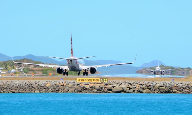 — — - Clear for take off? Virgin B737-800 waits for back tracking company jet