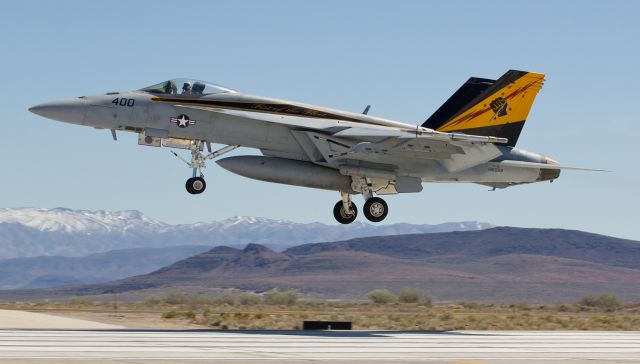 16-6959 — - My first of two posts for today is a snap of the VFA-25 "Fist Of The Fleet" CAG bird, an F/A-18E, passing over the keys of runway 31L as it returns to NAS Fallon after participating in a TOPGUN training sortie.  When at sea, VFA-25 flies from the USS Harry S. Truman (CVN-75).  NAS Oceana is the home port of the "Fist Of The Fleet" Super Bugs.