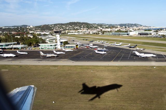 Airbus A320 (VP-BPW) - Departing LFMD for EGHI. Interesting image with Falcon shadow in grass near control tower just after take-off - image taken from port side of cabin Nikon 800E/24-70mm lens Tv2000th sec F7.1