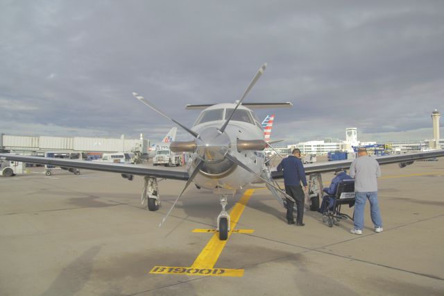 Pilatus PC-12 (N512NG) - A WWII veteran prepares to climb aboard the PC-12 to return to his home in Chadron, NE. from Denver, with a short stop in Alliance, NE. along the way.