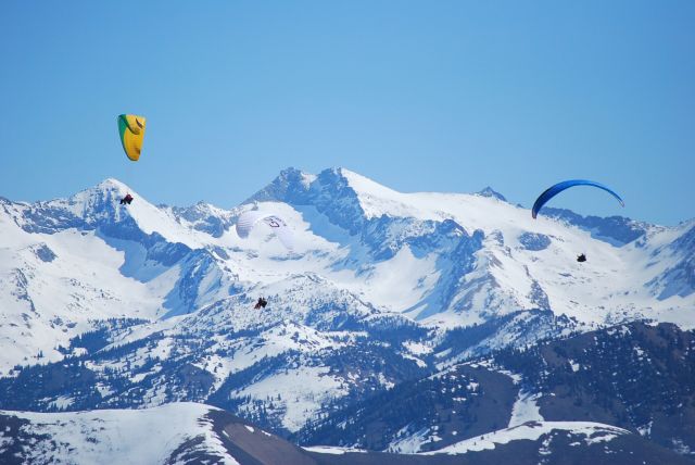 — — - Paraglider's flying over Baldy Ski Hill in Sun Valley Idaho with the Pioneer Mountains in the background