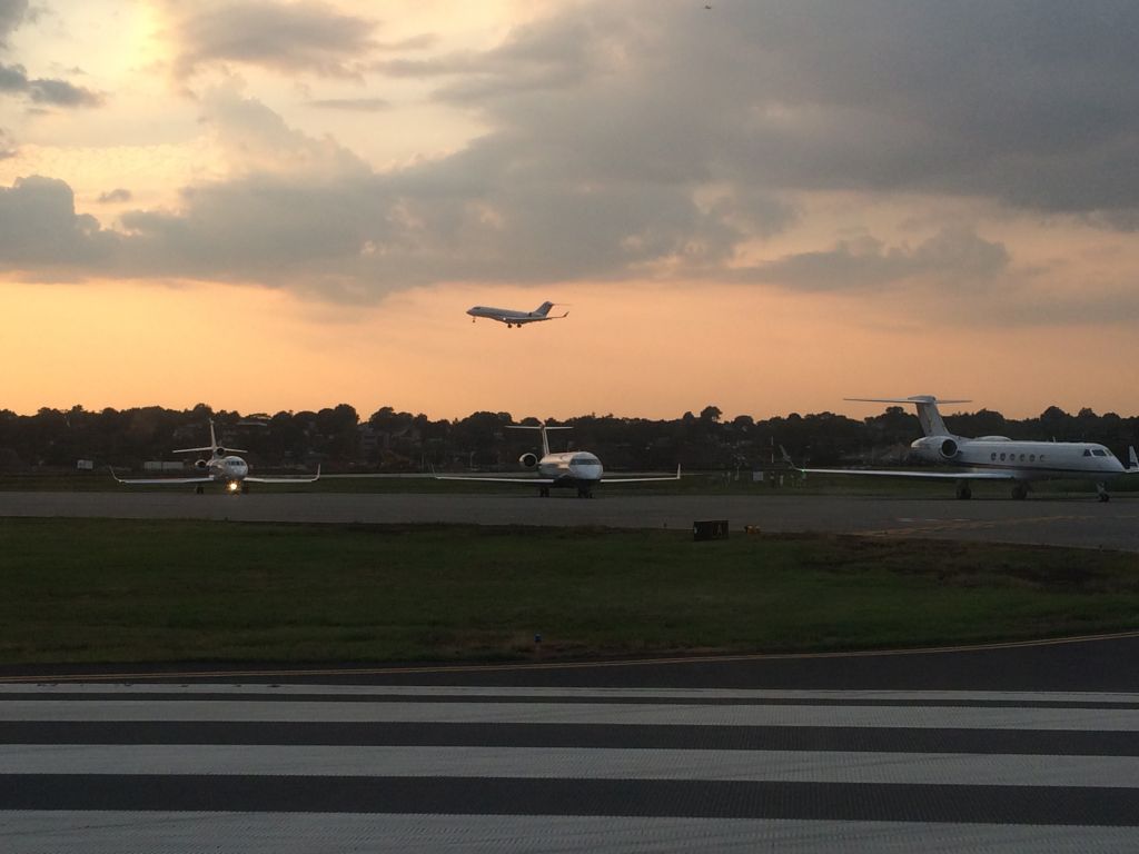 Gulfstream Aerospace Gulfstream V — - Line-up-and-wait on departure from KTEB.  Three jets waiting and one on short final with the sunset.