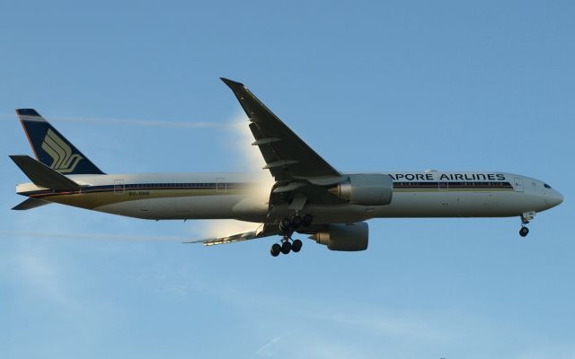 Boeing 777-200 (9V-SNB) - Condensation pours off the wings during early morning finals to RW27R, 11 Sept 2016.