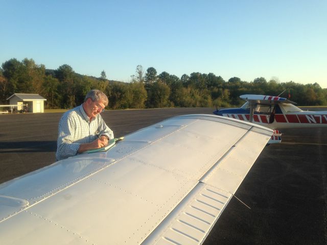 Piper Seneca (N1570X) - The ritual log book signing by an experienced jet pilot professional.  Notice the speed straps on the wing, and vortex generators.  Piper makes a good safe wing producing high lift and forgiving stall characteristics. 