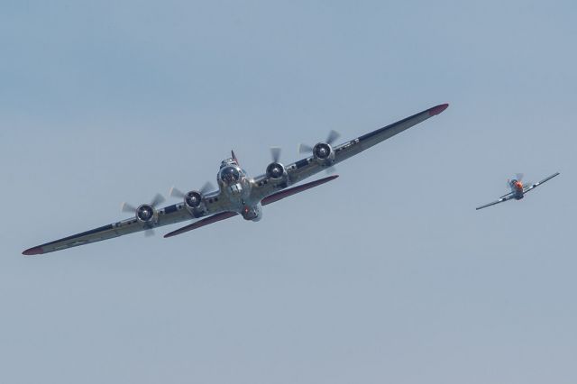 — — - The Yankee Air Museums B-17 Yankee Lady is escorted around the pattern at the Cleveland National Air Show by a locally produced Titan, a 3/4 scale P-51 replica.