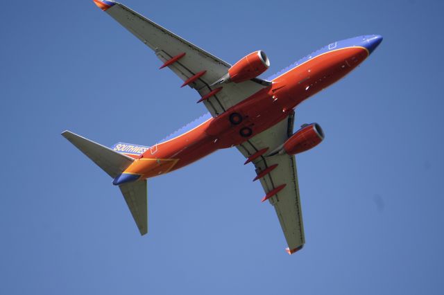 Boeing 737-700 (N740SW) - Photo taken from departure end of 16R. 1998 manufacture