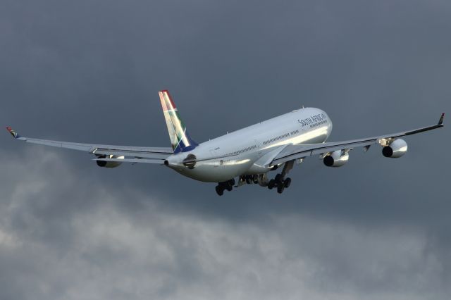 Airbus A340-300 — - SAA A340-300 departs LHR.