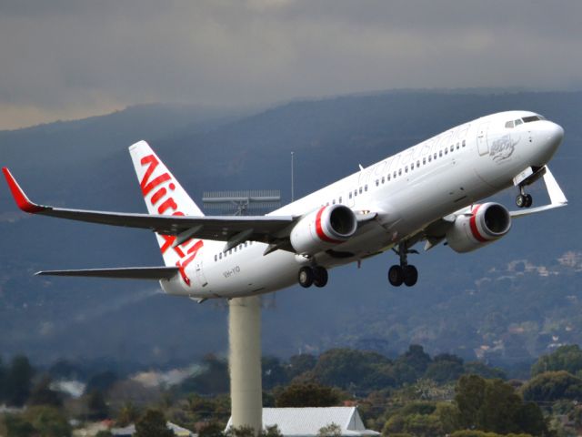 Boeing 737-800 (VH-YID) - Getting airborne off runway 23 on a cold, gloomy winters day. Wednesday 4th July 2012.