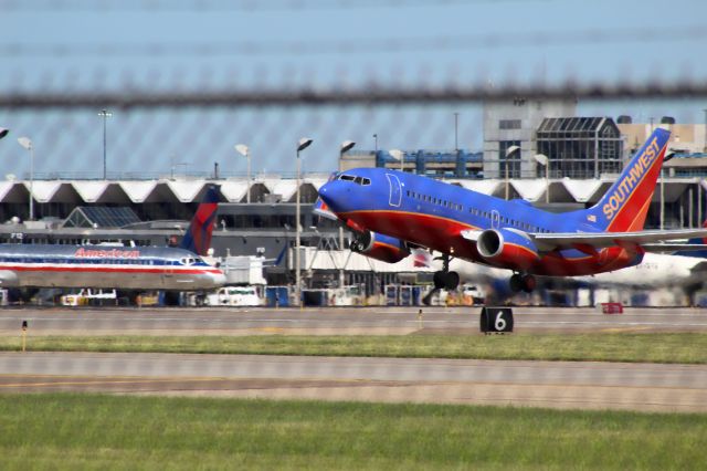 Boeing 737-700 (N963WN) - Taking off from MSP on Sunday June 4 with blue skies. The fence is in the way, but I though it gave it a cool effect. Also cool to see the engine thrust. 