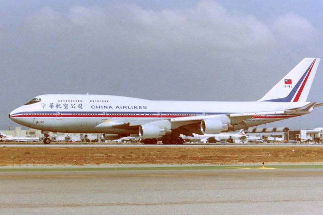 Boeing 747-400 (B162) - KLAX - China Airlines 747-400 rolling out on 25L at Los Angeles - photo from the Imperial Terminal parking lot( now closed ) CN 24310 LN 778 this jet re-reg to B-17272 and was eventually bought by Boeing 2006? and converted to the 747-400LCF as N780BA in 2007. Photo date here apprx Feb 1992.