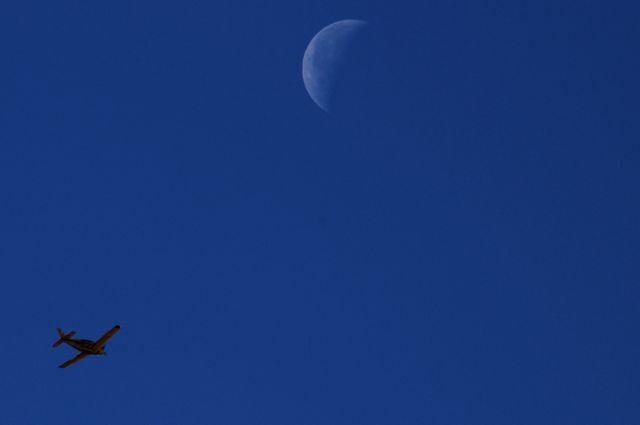 Piper Cherokee — - I wanted him to fly closer to the moon so I could get a closer shot,but he didnt coopperate quite that well.Oh well at least he flew that close.