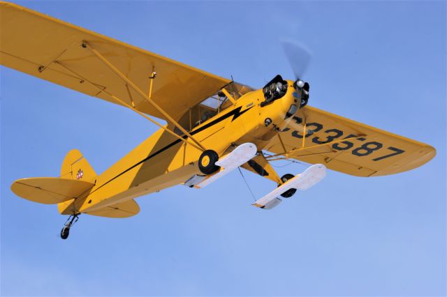 Piper NE Cub (N33587) - Flying over the frozen spectators.  