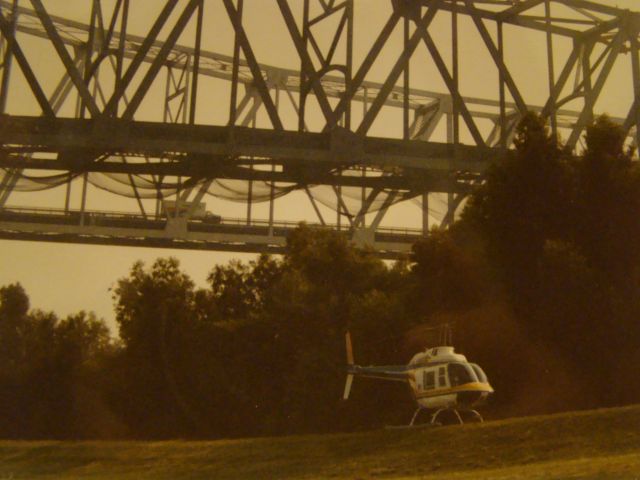 — — - The Bell 206 with the Greater New Orleans Bridge in the background. Its owned by Jeff Ward who ownes Louisiana Helicopters out of Westwego Airport. His Dad owned Ward lumber Co. lumber yards in Louisiana. Pilot Jerry Leonard.