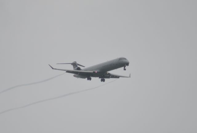 Canadair Regional Jet CRJ-900 (N547NN) - As the plane appears through the clouds, BOOM the vortices begin!