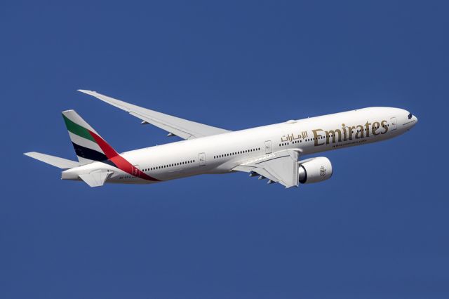 BOEING 777-300 (A6-EPA) - Climbing out of runway 13.
