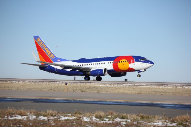 Boeing 737-700 (N230WN) - Southwest 904 departing runway 8 sporting the colors of the Colorado state flag.