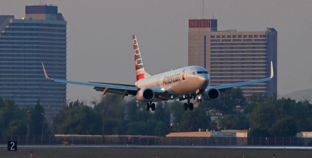 Boeing 737-800 (N834NN) - As reflected on the nose, a very small portion of the top of the sun is still just barely shining a few last rays of direct light over the rapidly-darkening airport grounds as Americans N834NN covers the final two thousand feet of flight before touching down on runway 16R.    