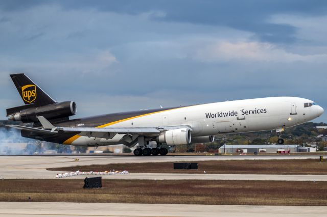 Boeing MD-11 (N256UP) - Coming down hard on 13R
