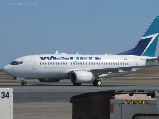Boeing 737-700 (C-FWAQ) - Just arriving at the gate at Halifax NS Airport .March 20/10