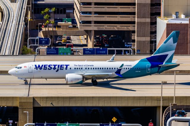 Boeing 737 MAX 8 (C-FNWD) - A WestJet 737 MAX 8 taxiing at PHX on 2/24/23. Taken with a Canon R7 and Canon EF 100-400 ii lens.