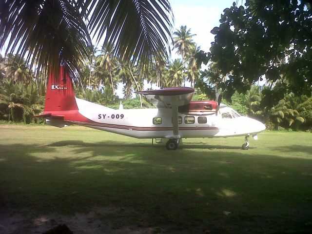 HARBIN Y-12 (SCX9) - Photo of the Harbin Y 12 owned an flown by Island Development Company (IDC) in the Seychelles island.  Photo shows SY009 parked after landing on the island if Ile Platte in the Seychelles.  The airstrip is grass and is lined by tropical trees.  I took this as I waited to reboard and fly to the main island of Mahe, this in early April 2013.