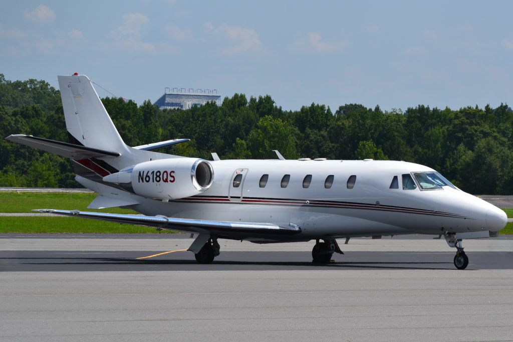 Cessna Citation Excel/XLS (N618QS) - NETJETS "Exec Jet" with the Charlotte Motor Speedway in the background at KJQF - 8/6/18
