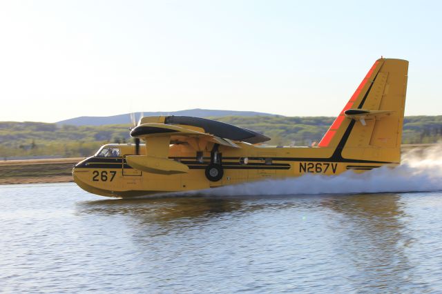 — — - Scooping water from the float plane pond.