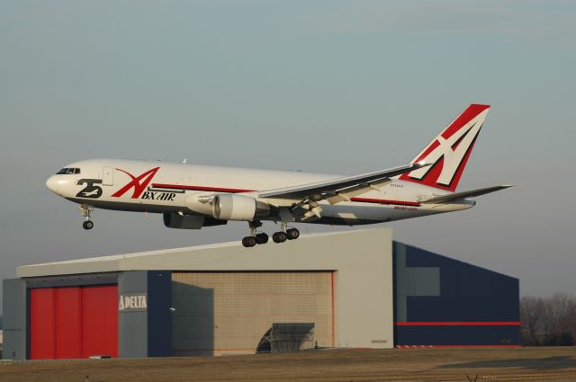 BOEING 767-200 (N792AX) - A Boeing 767-200 Frighter on a very short final to 18L, with the Delta hanger in the back round, this 1 also shows the 25 years of service logo    this photo was picked by the staff pixs, i can be reached at Truck10FMFD@aol.com for questions or comments