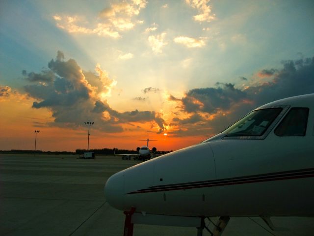 — — - Learjet parked on the ramp at KAPF