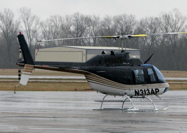 Bell JetRanger (N313AP) - At Downtown Shreveport in the pouring rain. This aircraft is owned by Andy Petree who is a  NASCAR owner or something but he bought the aircraft from NASCAR driver Greg Biffle.