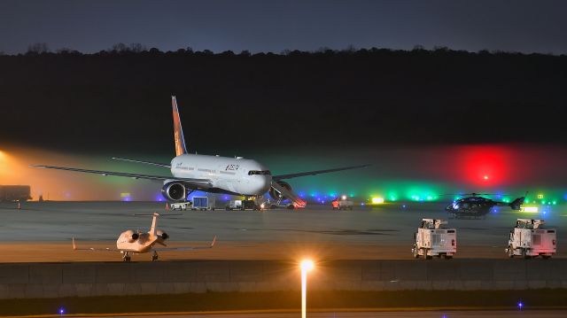 BOEING 767-400 (N829MH) - Delta Airlines Boeing 767-400 (N829MH) on the RDU GA ramp with Duke's helicopter N774DU in the foreground on 11/26/2020 at 8:37 pm. Delta brought the Notre Dame football team who are playing UNC at Kenan Stadium tomorrow afternoon, 11/27/2020.